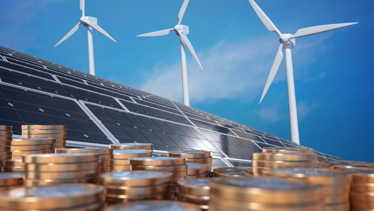 solar panels and wind mills in front of blue sky and behind stacks of money coins