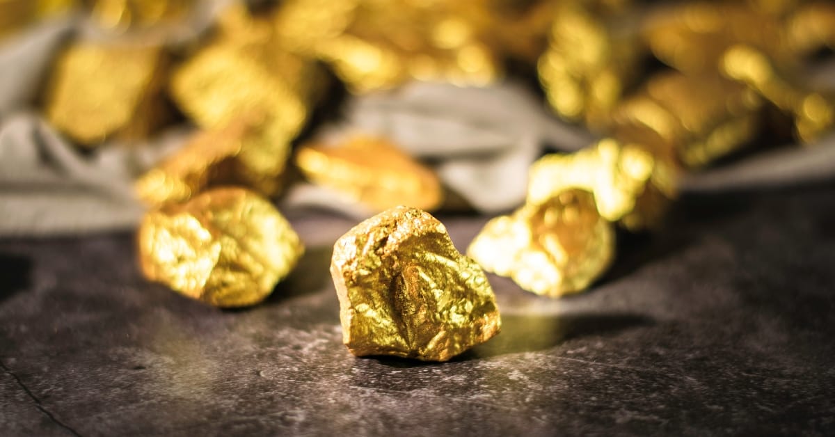 precious metals gold nuggets on stone granite table top